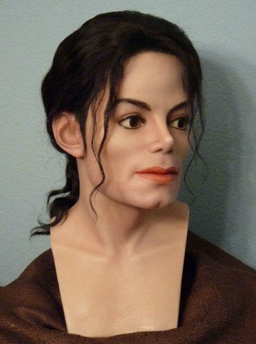 Detailed portrait shot of Michael Jackson waxwork showing realistic face and hair detail.