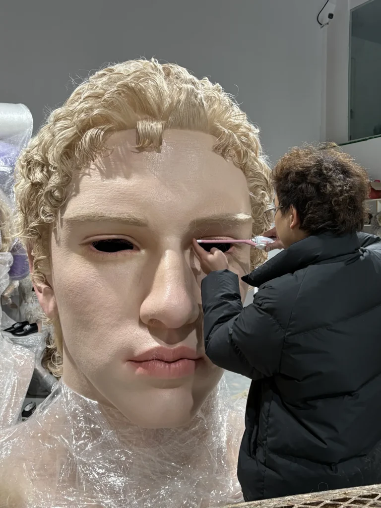 Large-scale human face sculpture prepared in the production workshop.