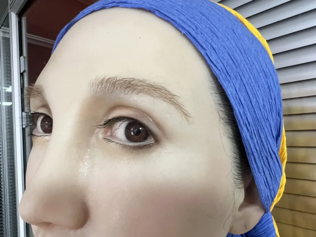 Close-up craftsmanship of the Girl with a Pearl Earring wax bust.
