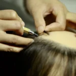 Individual hair application on a wax portrait