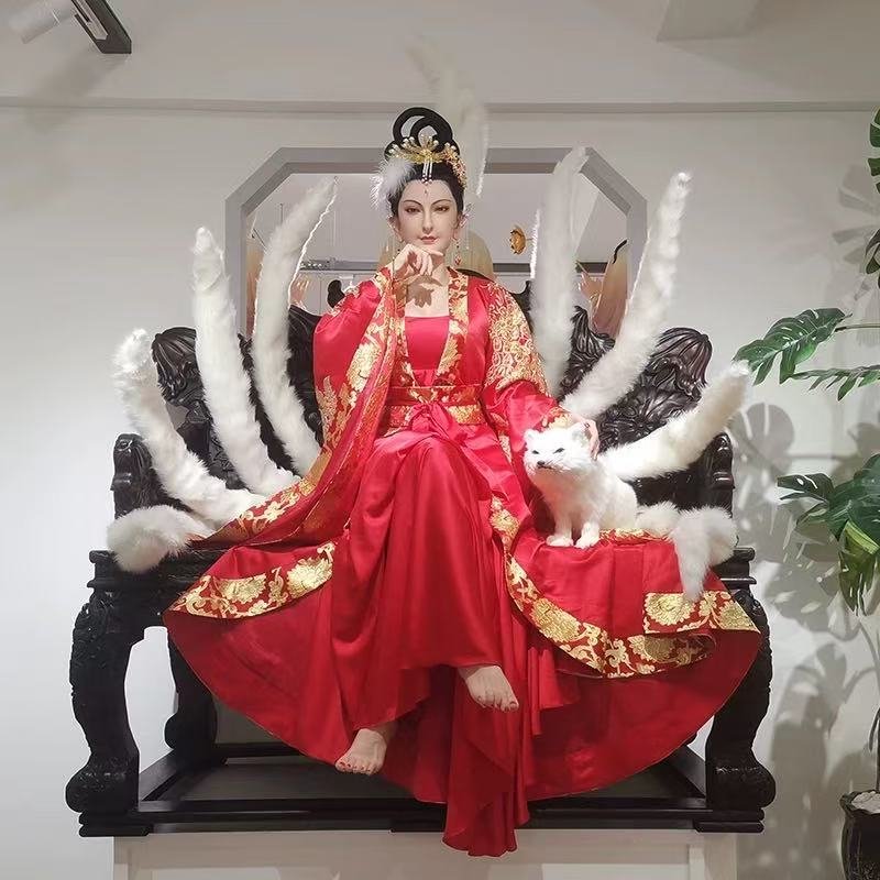 Nine-tailed mythical character wax figure in ceremonial red dress