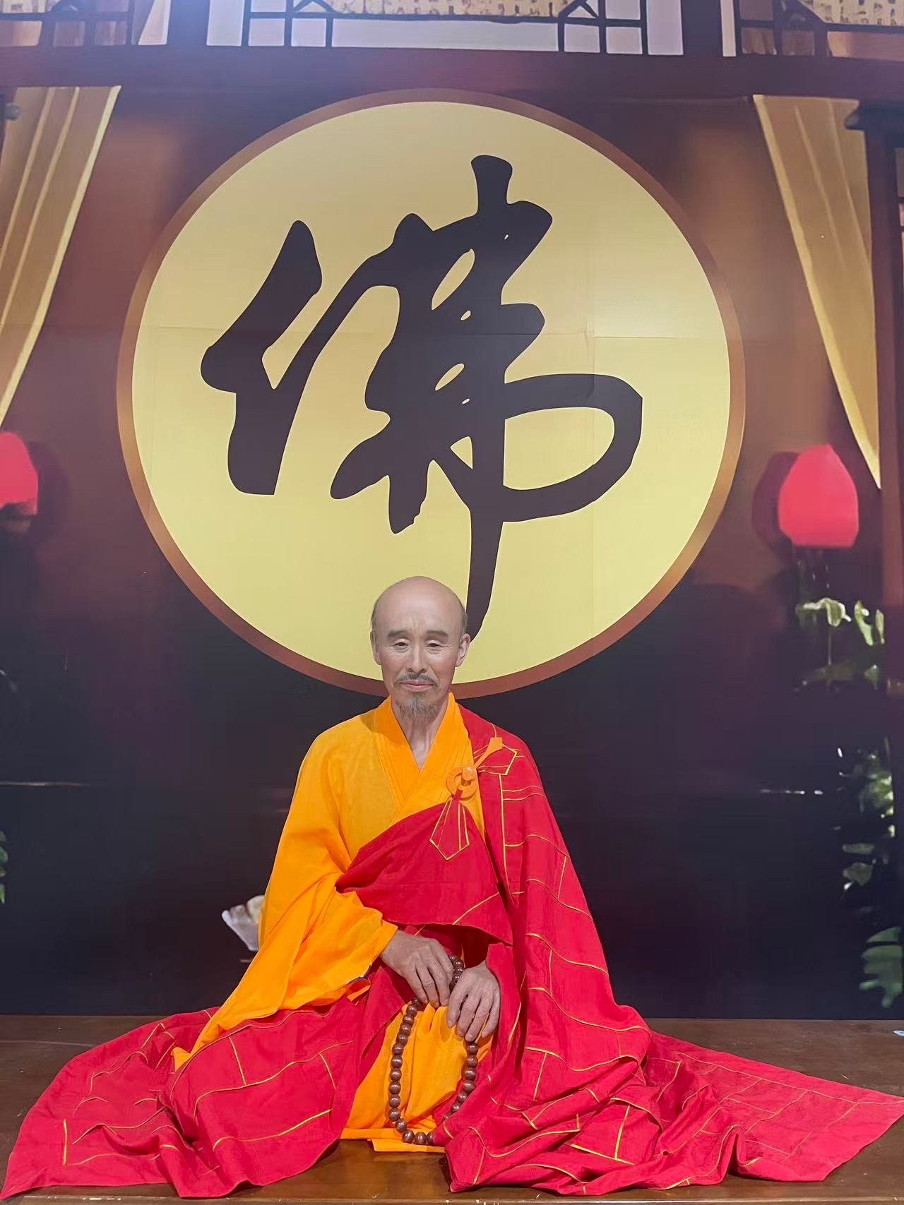 Bespoke seated Buddhist portrait before a calligraphy backdrop