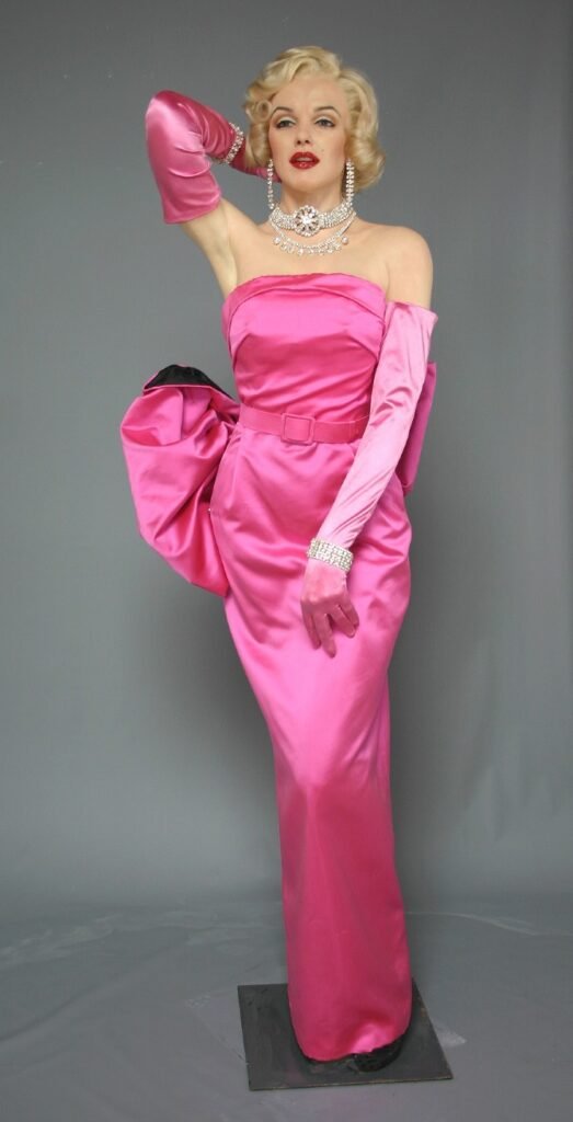 Marilyn Monroe wax figure arranged in pink evening gown for museum display.